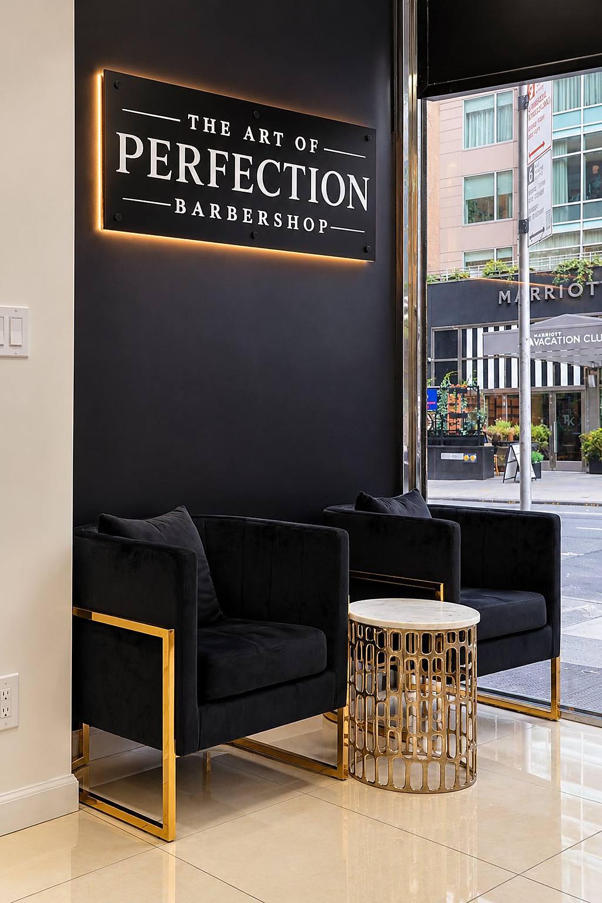 The Art of Perfection barbershop sign and waiting area