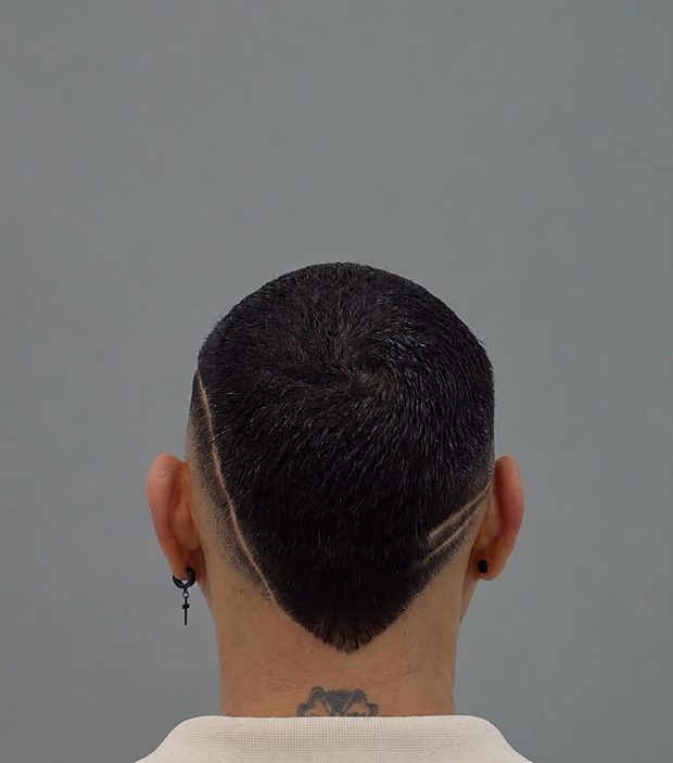 Back view of a taper fade with shaved design lines and a sharp neckline — barber work at The Art of Perfection, NYC